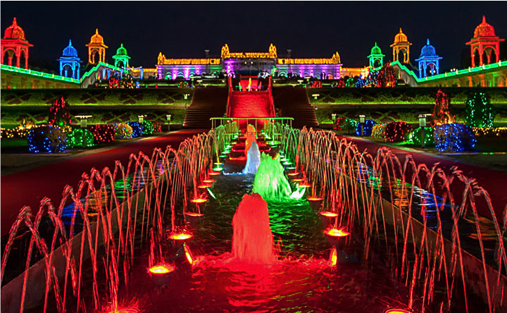 Royal wedding set in Hyderabad at Ramoji Film City with colorful lights, illuminated fountains, and majestic architecture at night